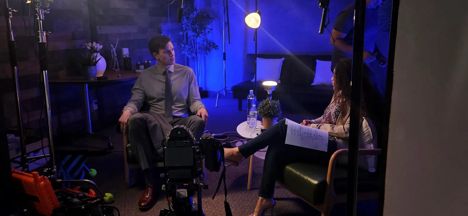 On set — wide of the same scene showing the lighting setup