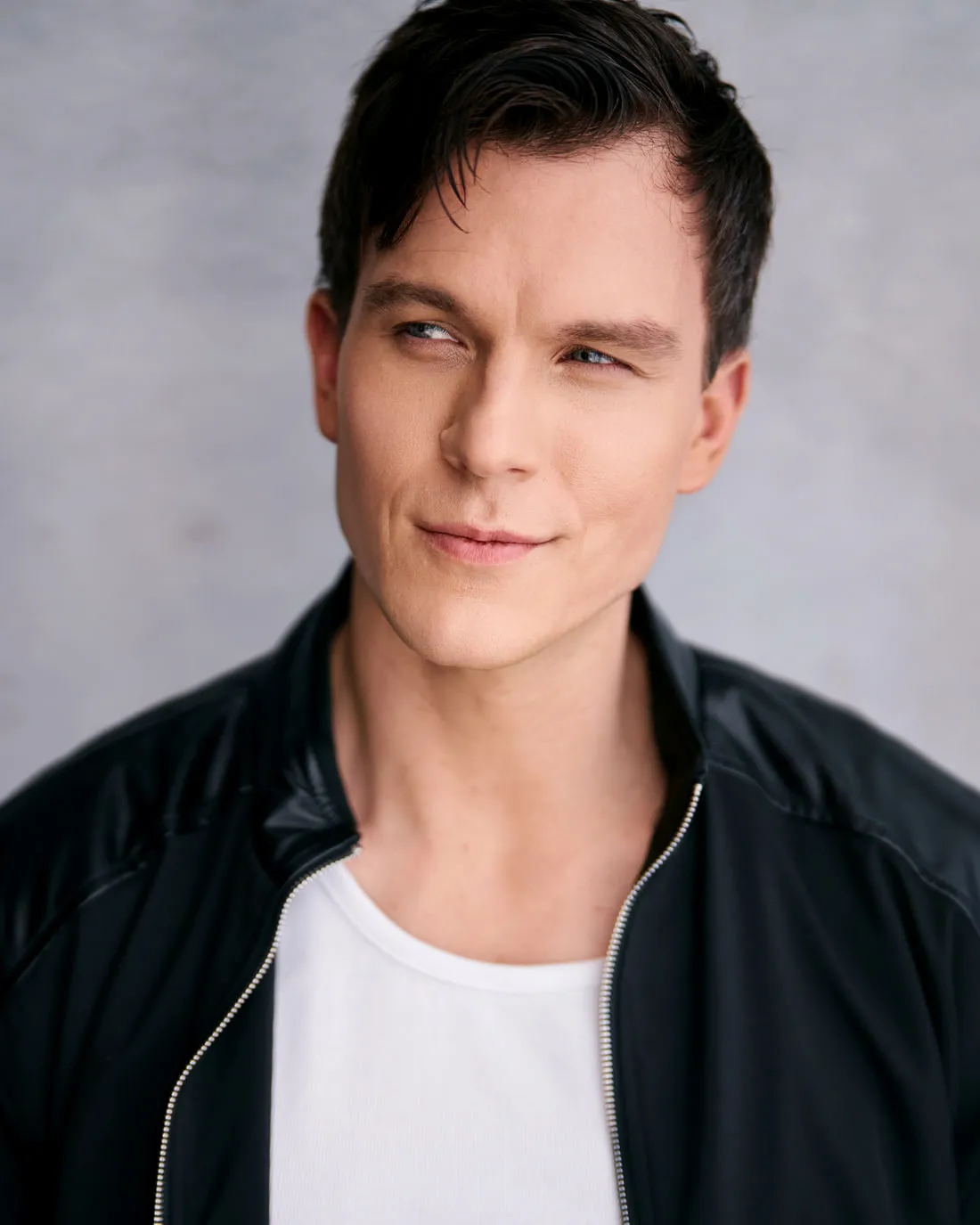 Steven Roderick Jurich in a black bomber jacket over a white tee