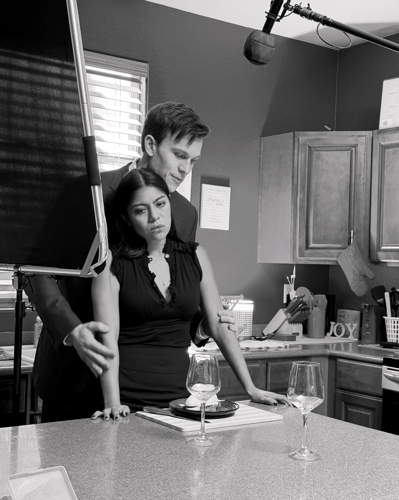 Or Death, behind the scenes — a scene partner at the kitchen counter, boom overhead
