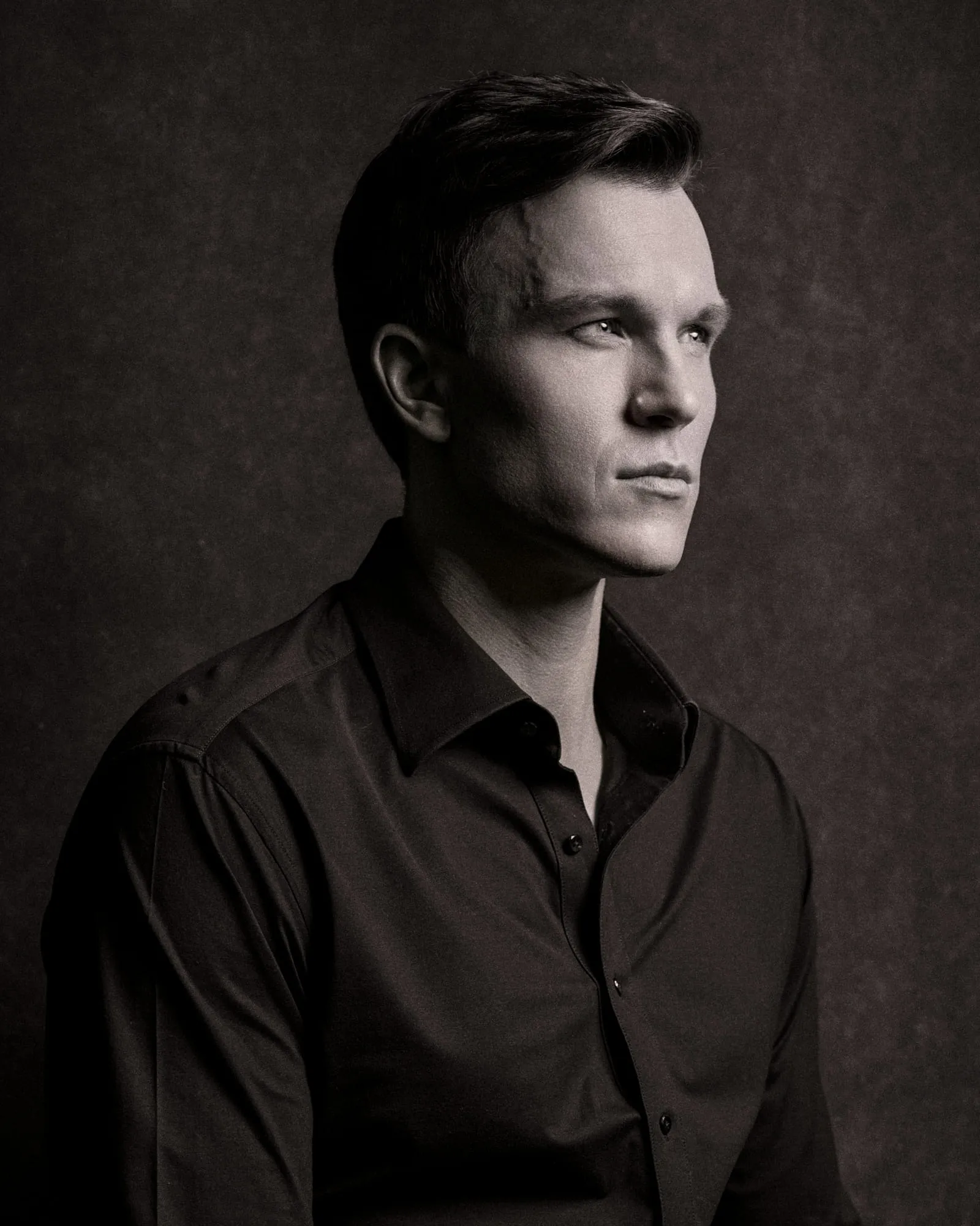 Steven Roderick Jurich in black and white, turned three-quarters into shadow